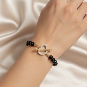 Bracelet with heart-shaped charm .